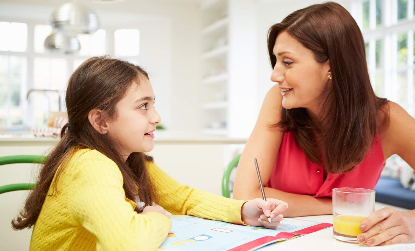 Maria with her daughter doing homework at the kitchen table in 2025, supported by a JellyLoans title loan in Austin, TX, for back-to-school expenses.